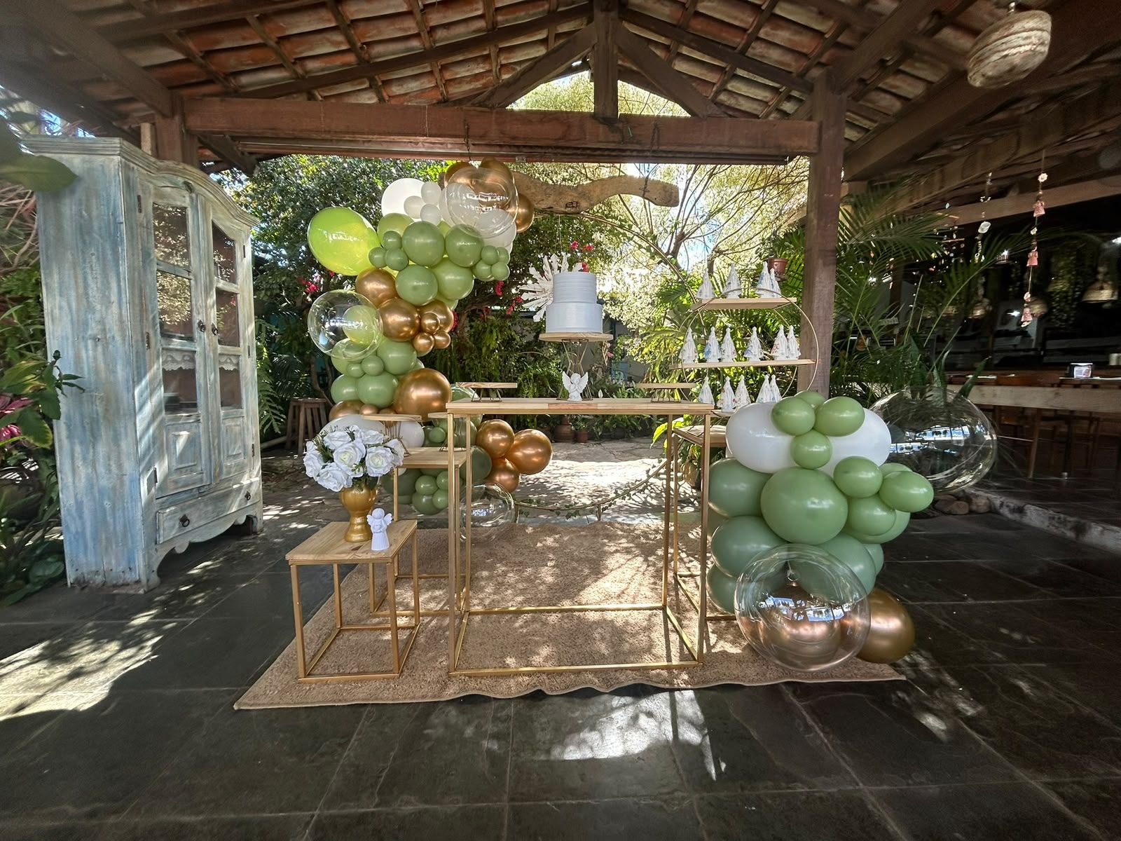 Decoração de batizado em verde sage e dourado com balões e anjinhos